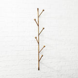 NEW Barker Sculptural Vertical Wall Mounted Coat Rack, crafted from Iron with a warm gold finish, also ideal in the bedroom for necklaces, scarves, and your favorite cozy robe.