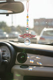 New Acrylic Crystal guardian angel sun catcher and car charm, featuring a colourful beaded strand, floral-patterned acrylic wings, and a faceted crystal prism, light pink hanger