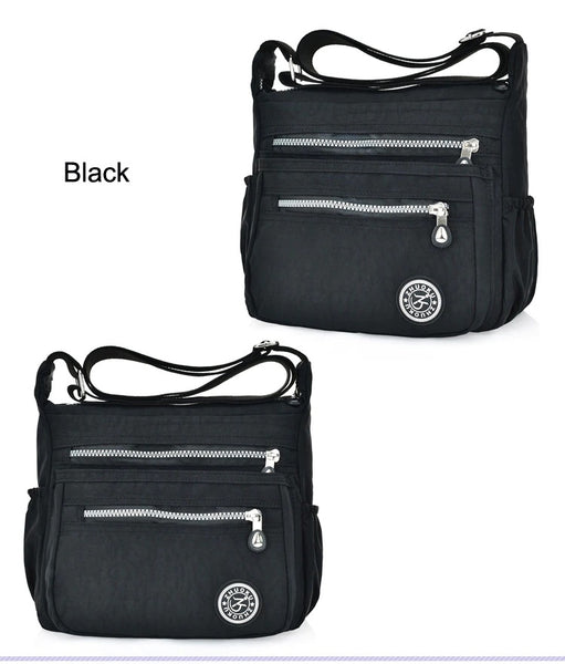New women's Nylon cross body water repellant bag in Black! Tons of storage space with 5 zippered pouches