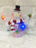 Brand new in box! Glitter in Motion light up LED Snowman Globe! Battery operated, batteries included Approx 9 Inches High