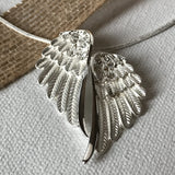 Anything is possible when you have wings! Wing Necklace, accented with diamond faceting and cubic zirconias, includes gift box with verse